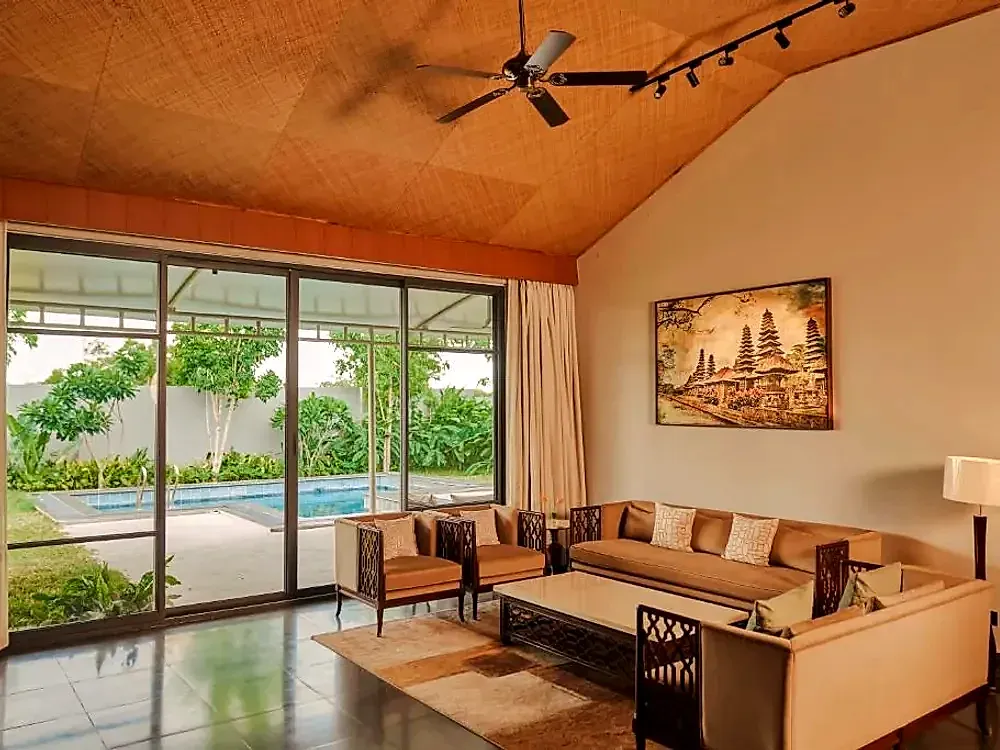 Villa living room opening onto a private pool